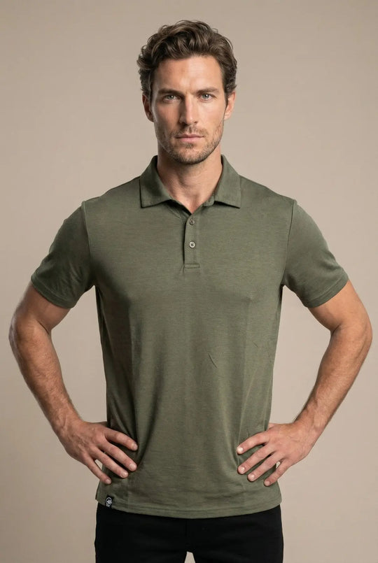 Man wearing a green polo shirt against a beige background