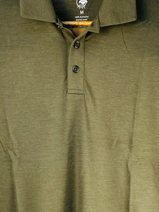 Close-up of a green polo shirt with a brand label on the collar.
