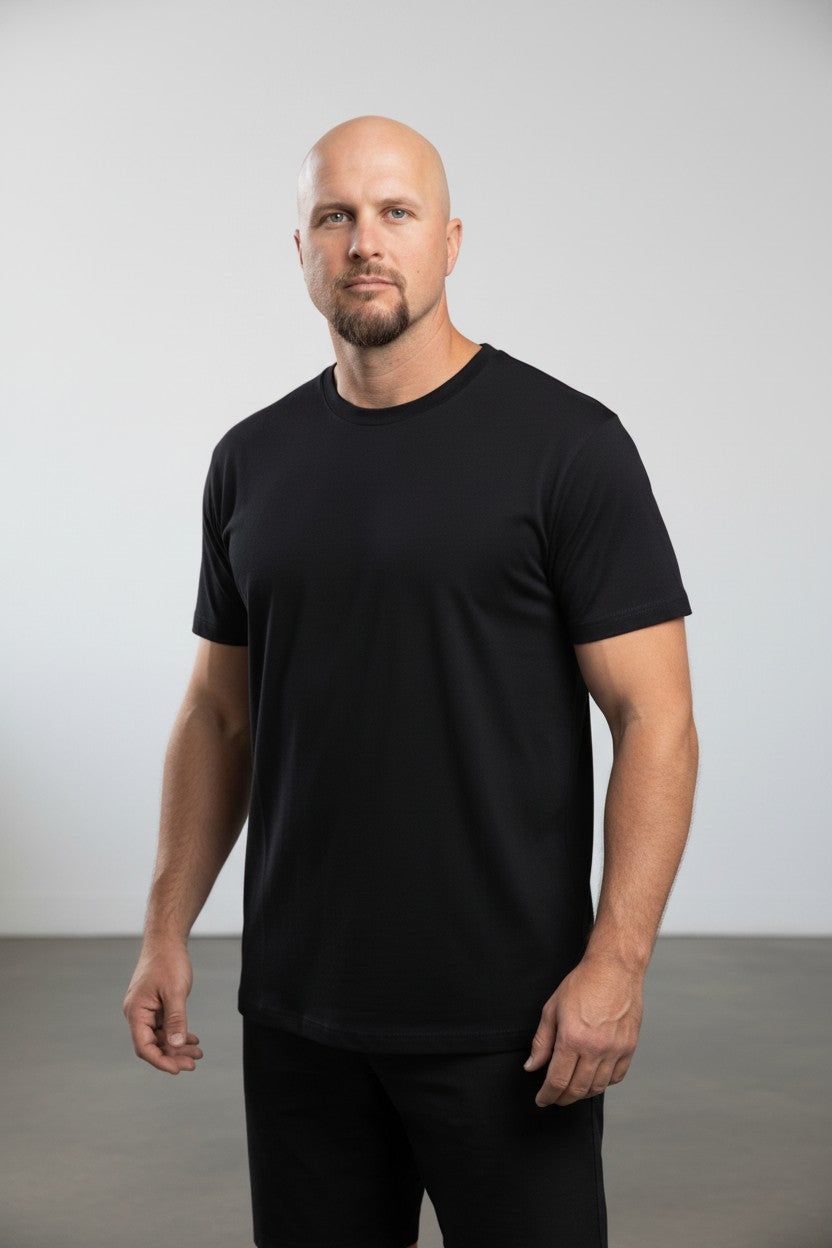 Man wearing a black t-shirt against a plain background
