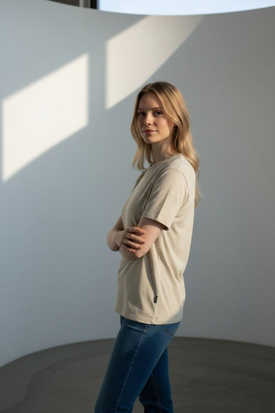 A lady wearing a camel-colored wool t-shirt.
