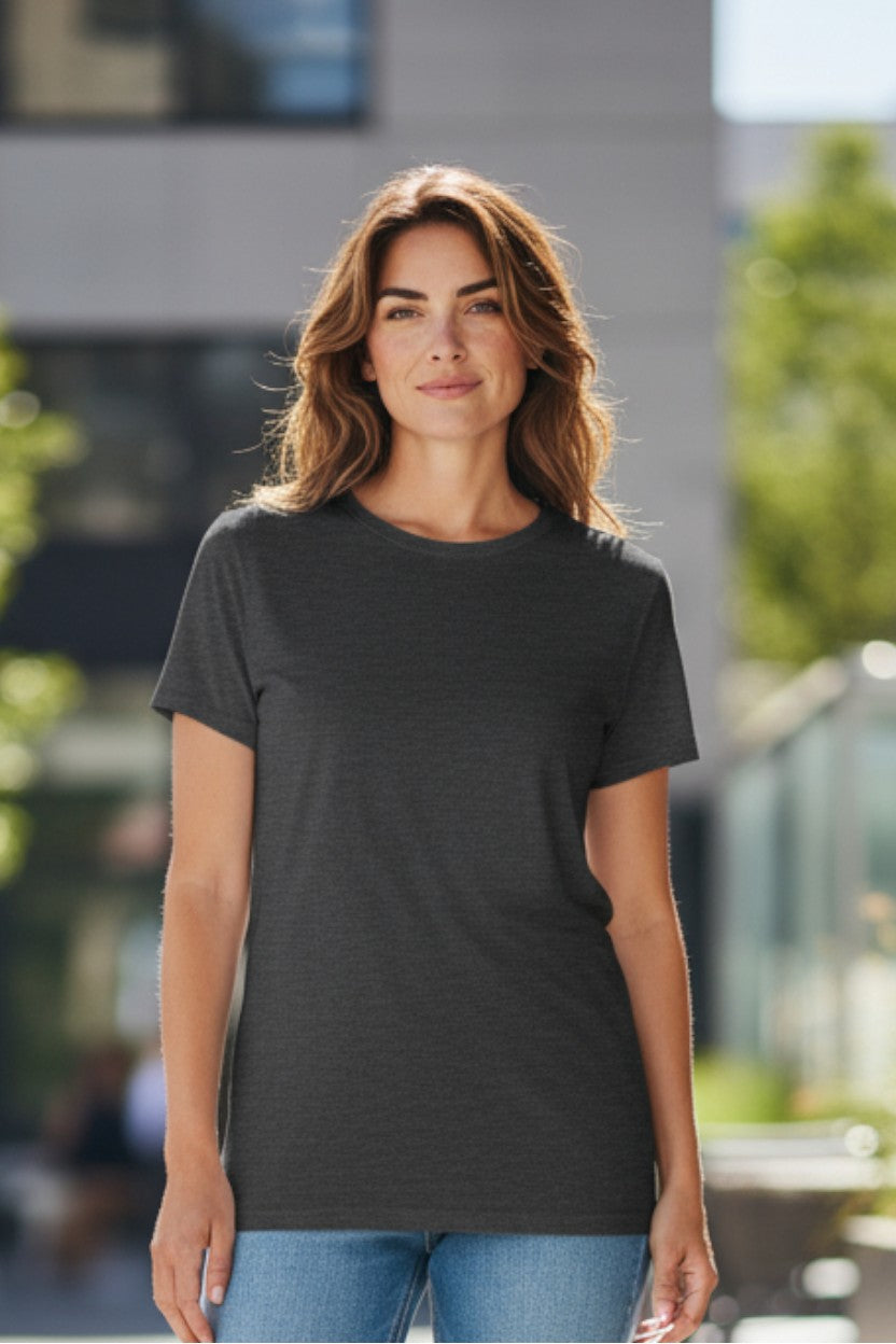 Woman wearing a black t-shirt standing outdoors with blurred background
