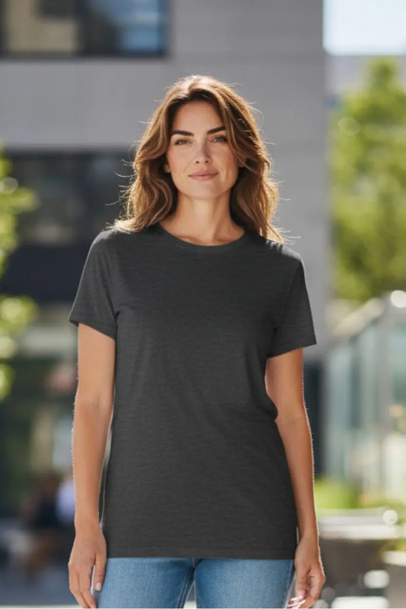 Woman wearing a black t-shirt standing outdoors with blurred background
