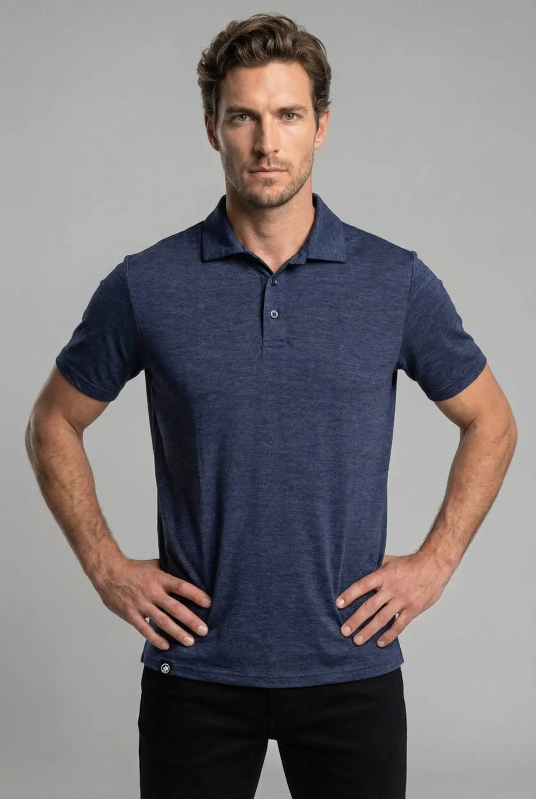 Man wearing a blue polo shirt against a gray background
