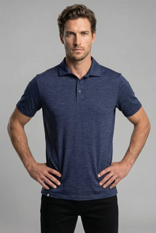 Man wearing a blue polo shirt against a gray background