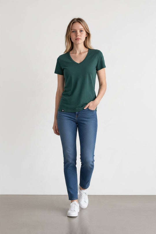 woman in green merino wool t-shirt and blue jeans