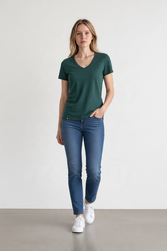 woman in green merino wool t-shirt and blue jeans