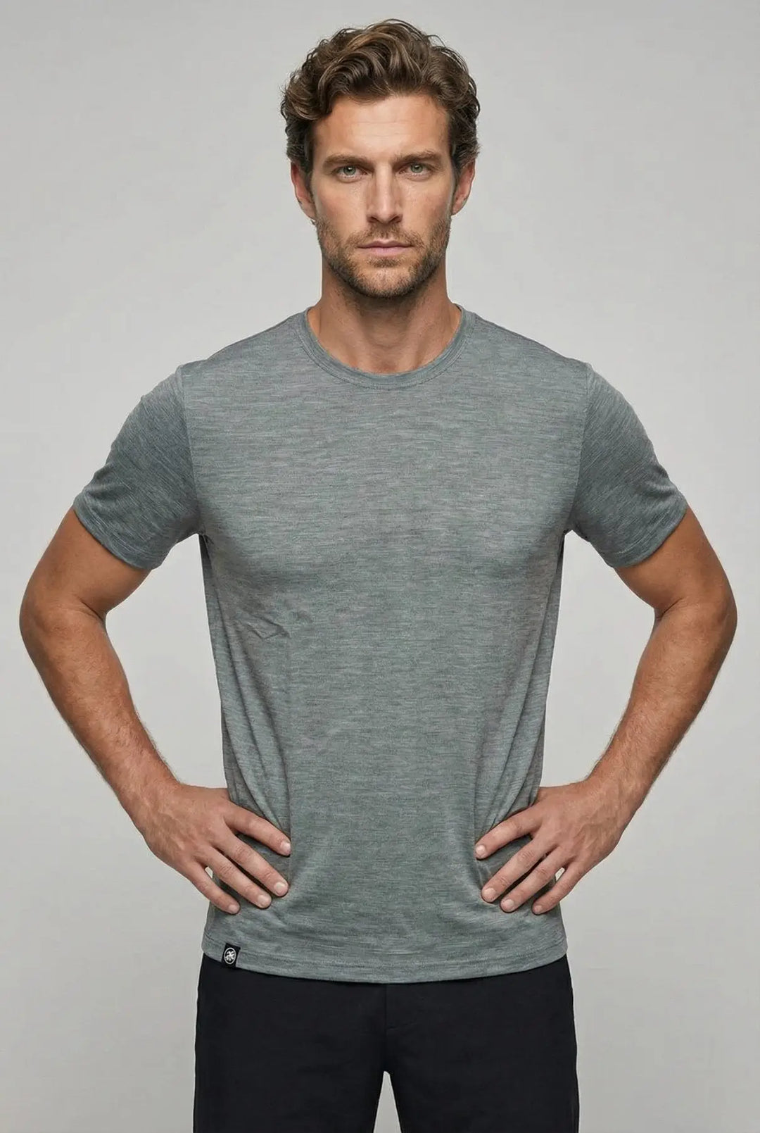 Man wearing a gray t-shirt against a plain background