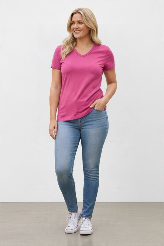 woman in pink merino wool t-shirt and blue jeans