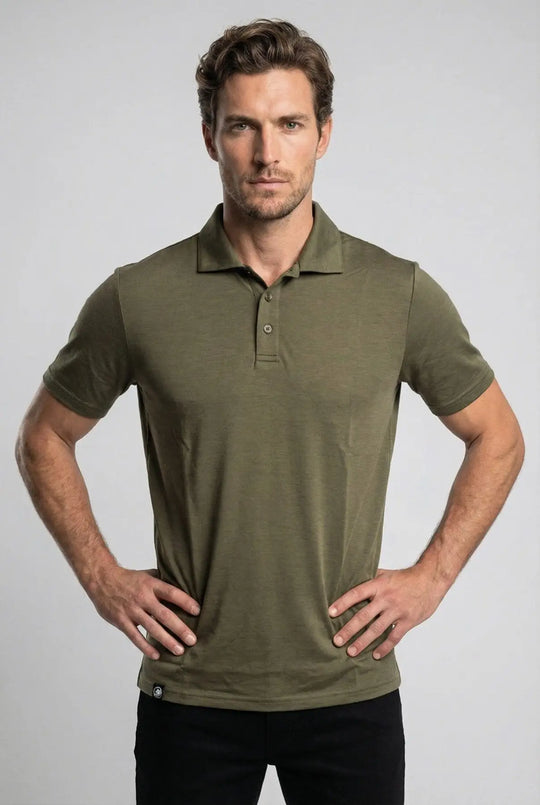 Man wearing an olive green polo shirt against a gray background