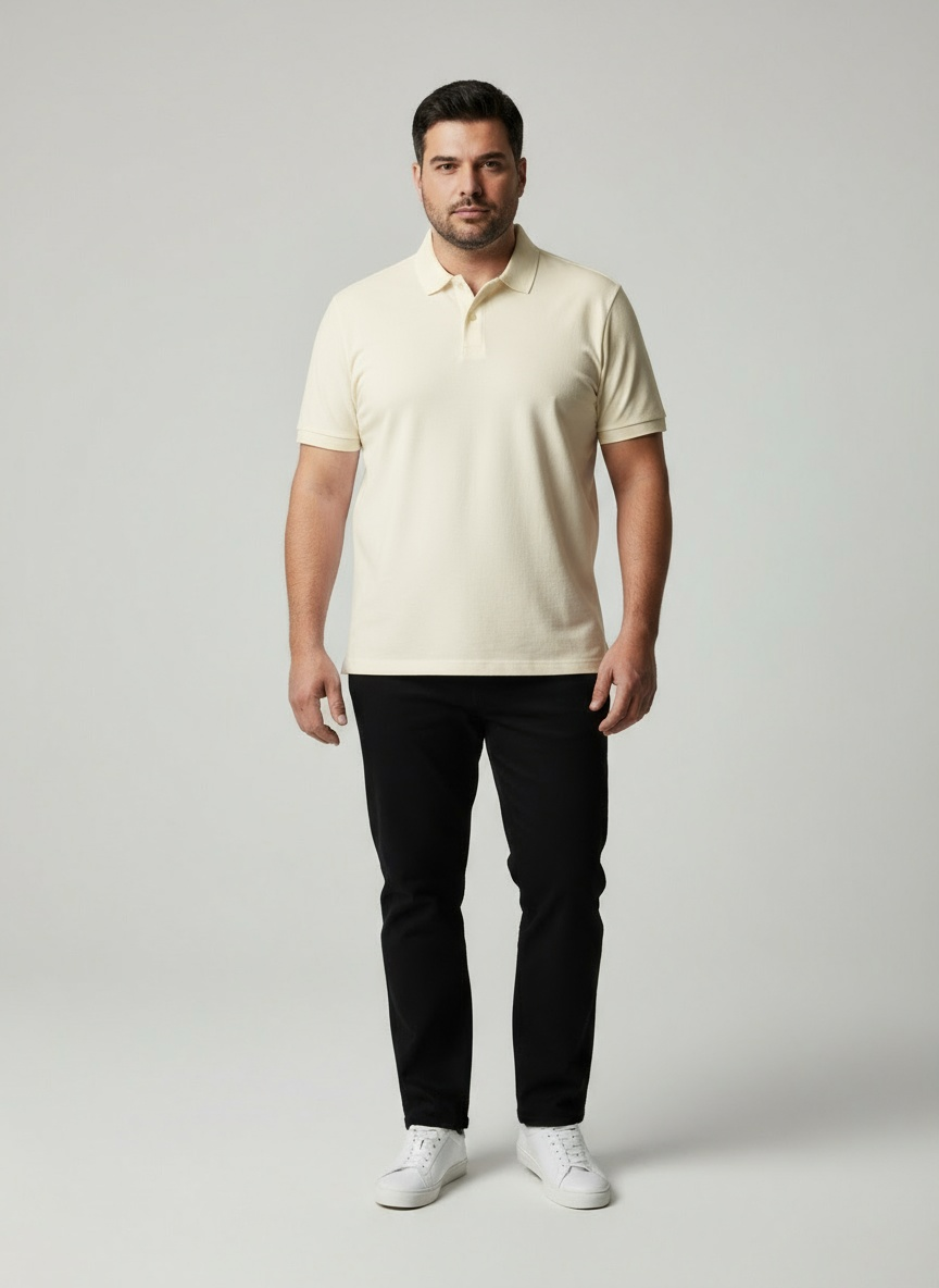 Man wearing a beige polo shirt and black pants on a gray background