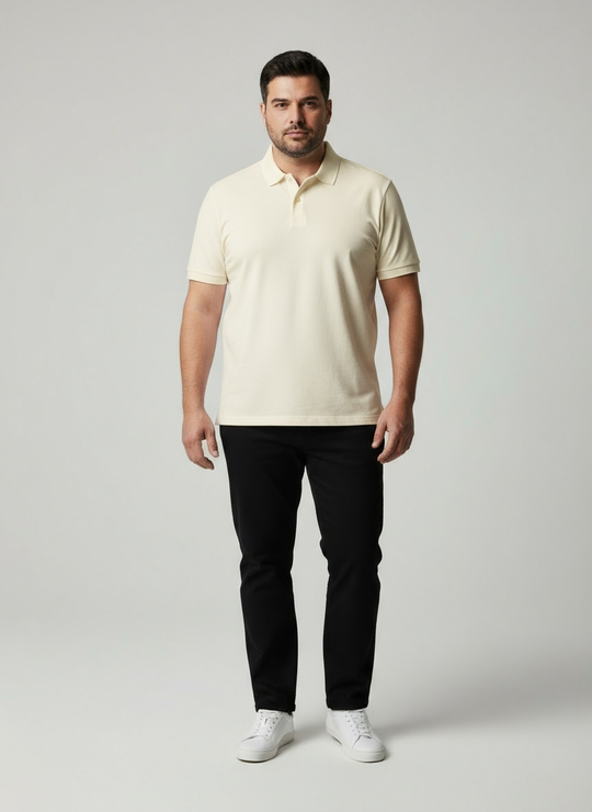 Man wearing a beige polo shirt and black pants on a gray background