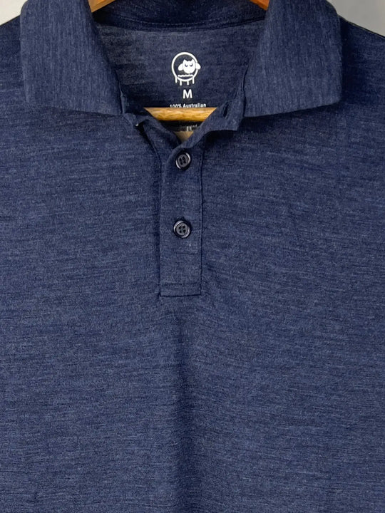 Close-up of a blue polo shirt with a brand logo on a hanger