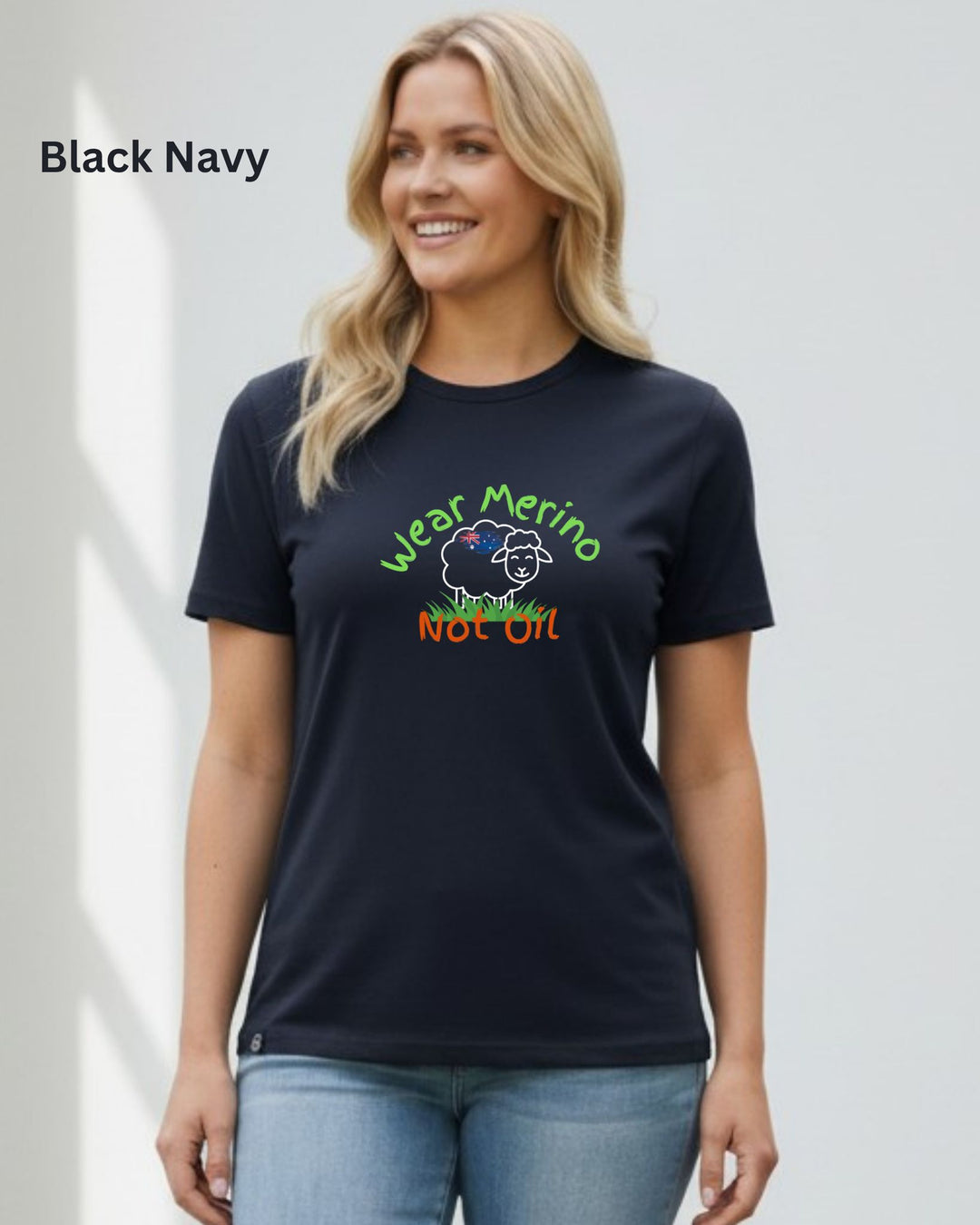 A woman wearing a navy blue t-shirt with a colorful graphic that reads &