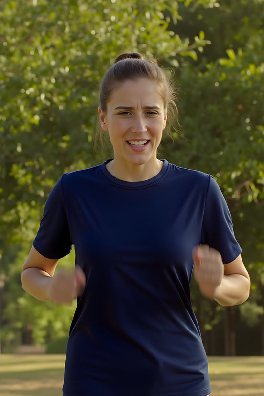 Woman exercising outdoors with trees in the background wearing wool t-shirt