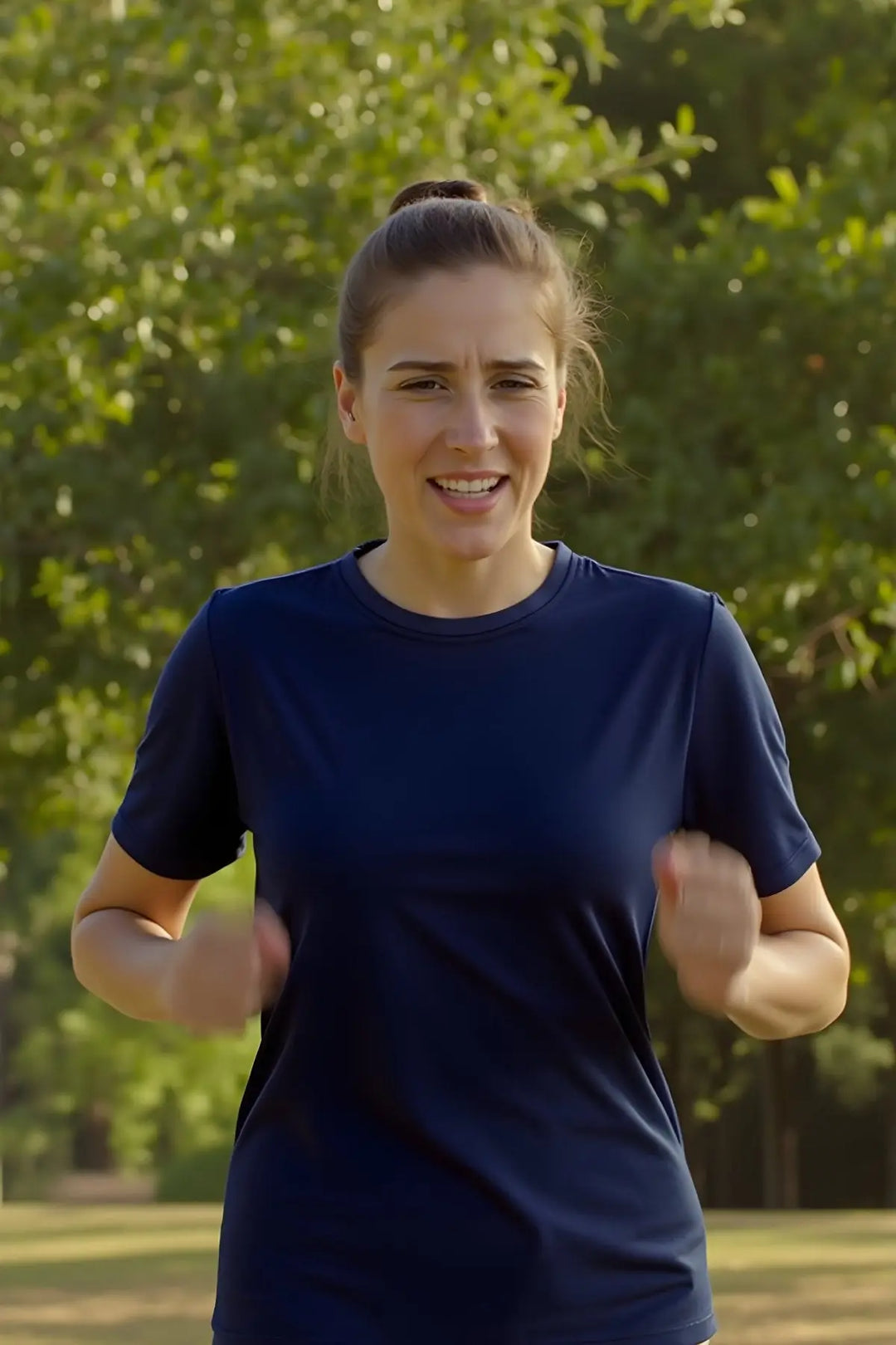 Woman exercising outdoors with trees in the background wearing wool t-shirt