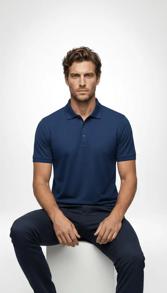 Man in blue polo shirt sitting on stool