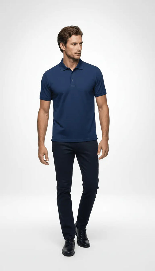 Man wearing a navy blue polo shirt and pants on a white background