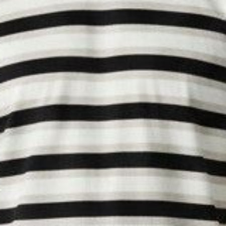 A man wearing a black and white horizontally striped short-sleeve t-shirt, dark blue jeans, and white sneakers, standing against a light gray studio background.