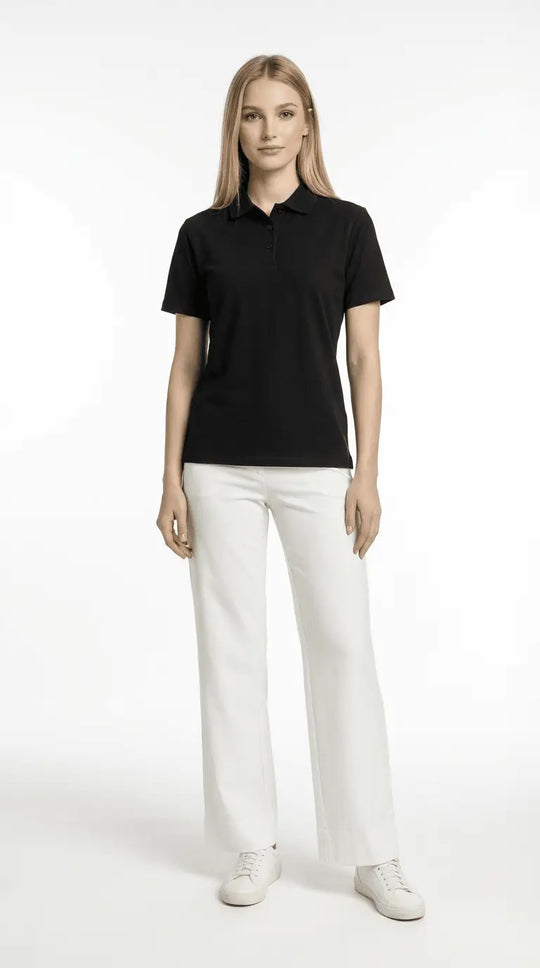 Woman wearing a black polo shirt and white pants on a white background